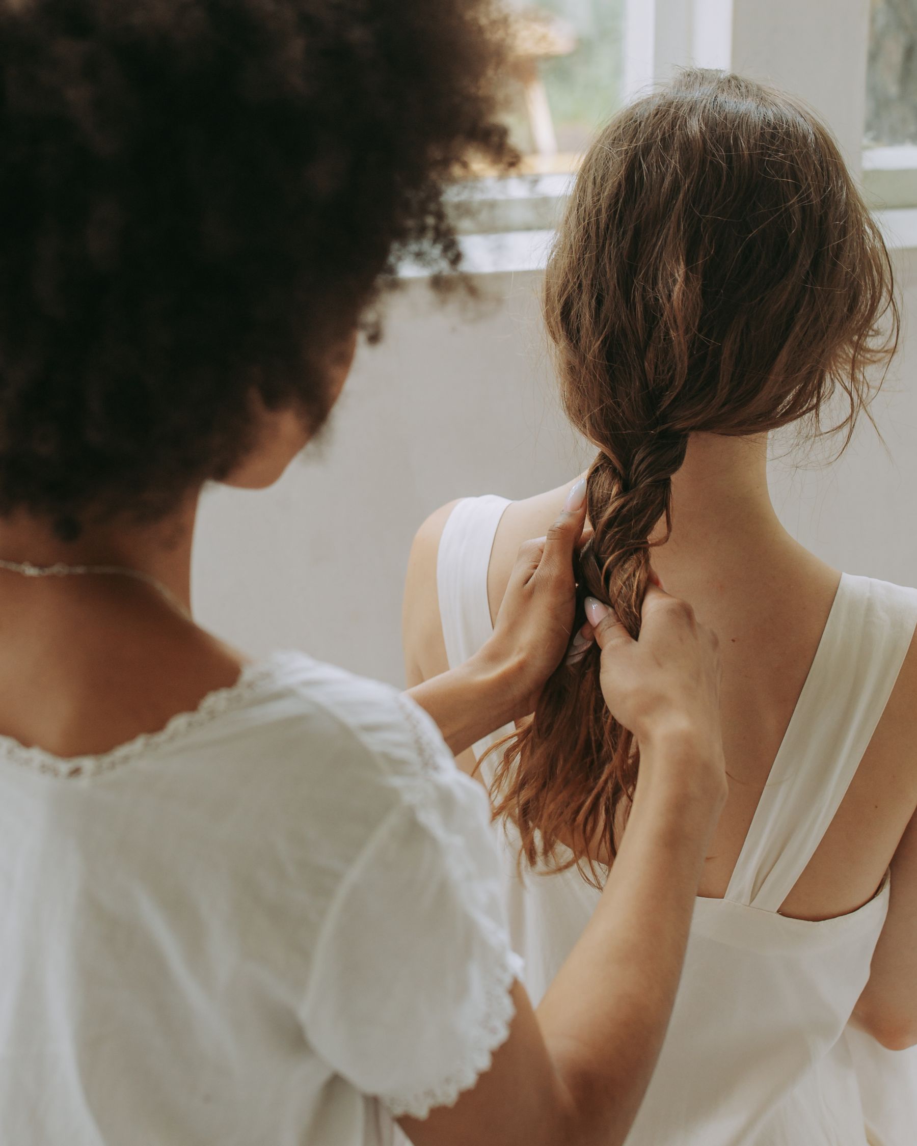 Stylist braiding long hair