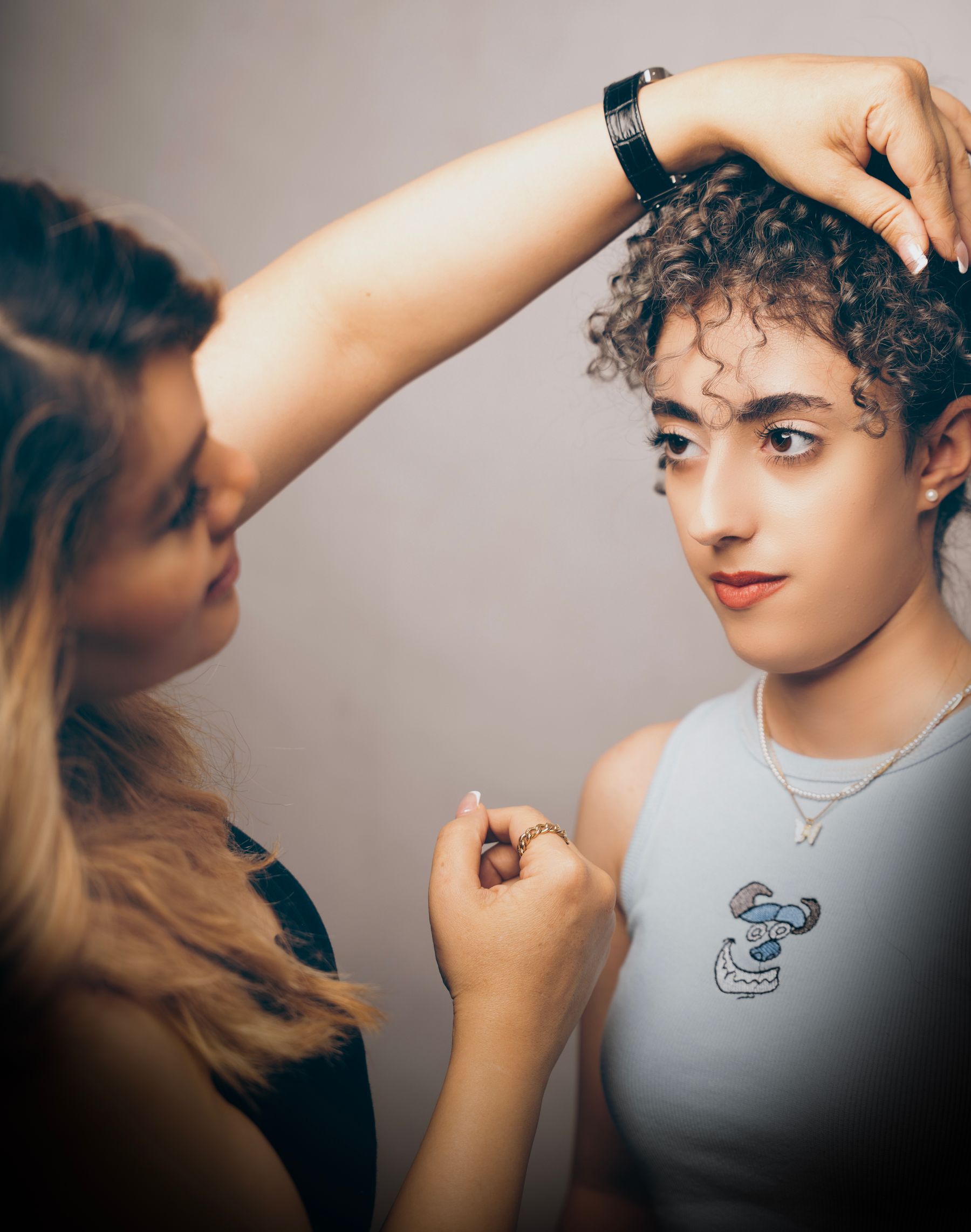 Stylist shaping a client's curly hair