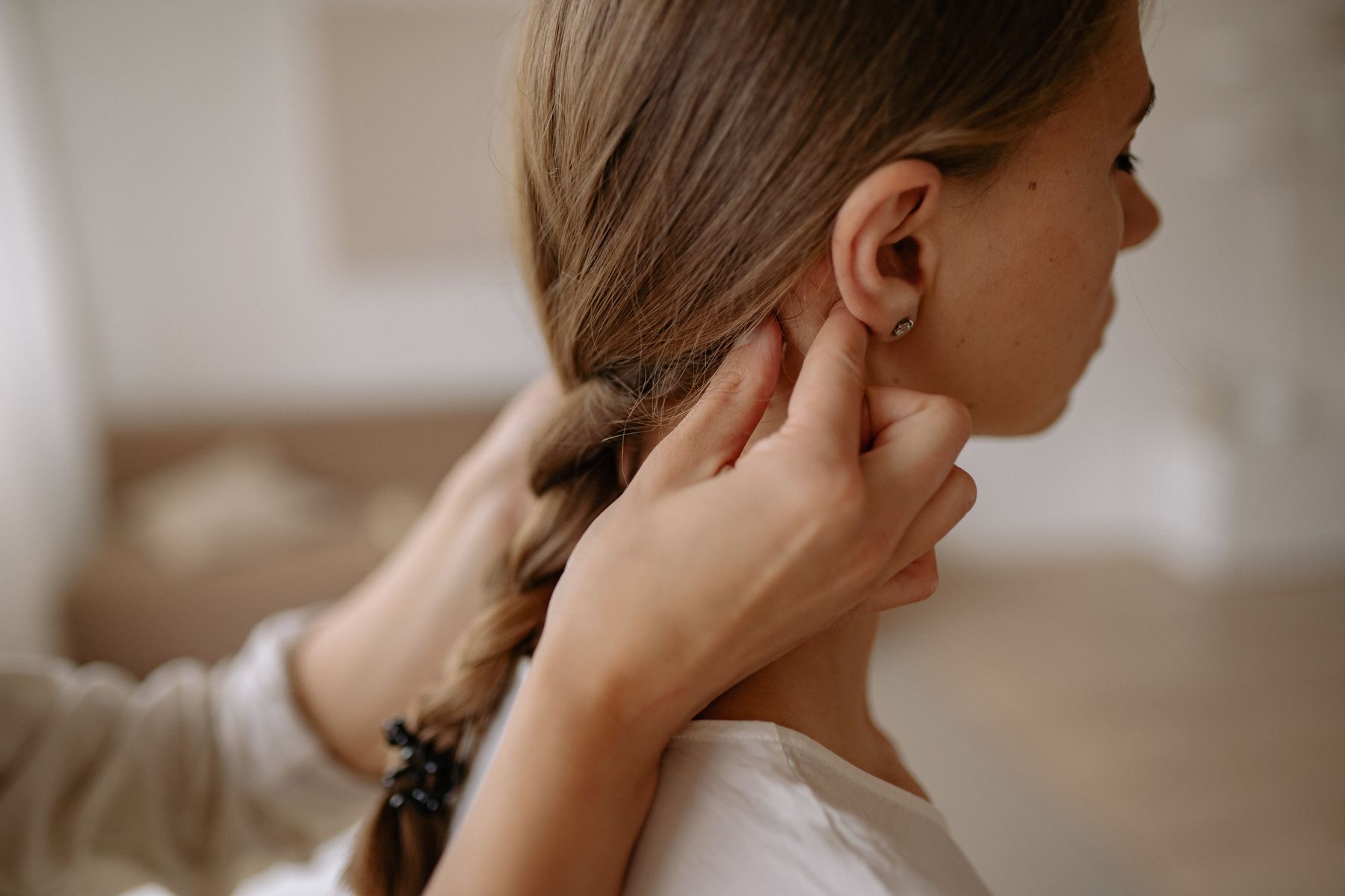Hands plaiting a client's hair
